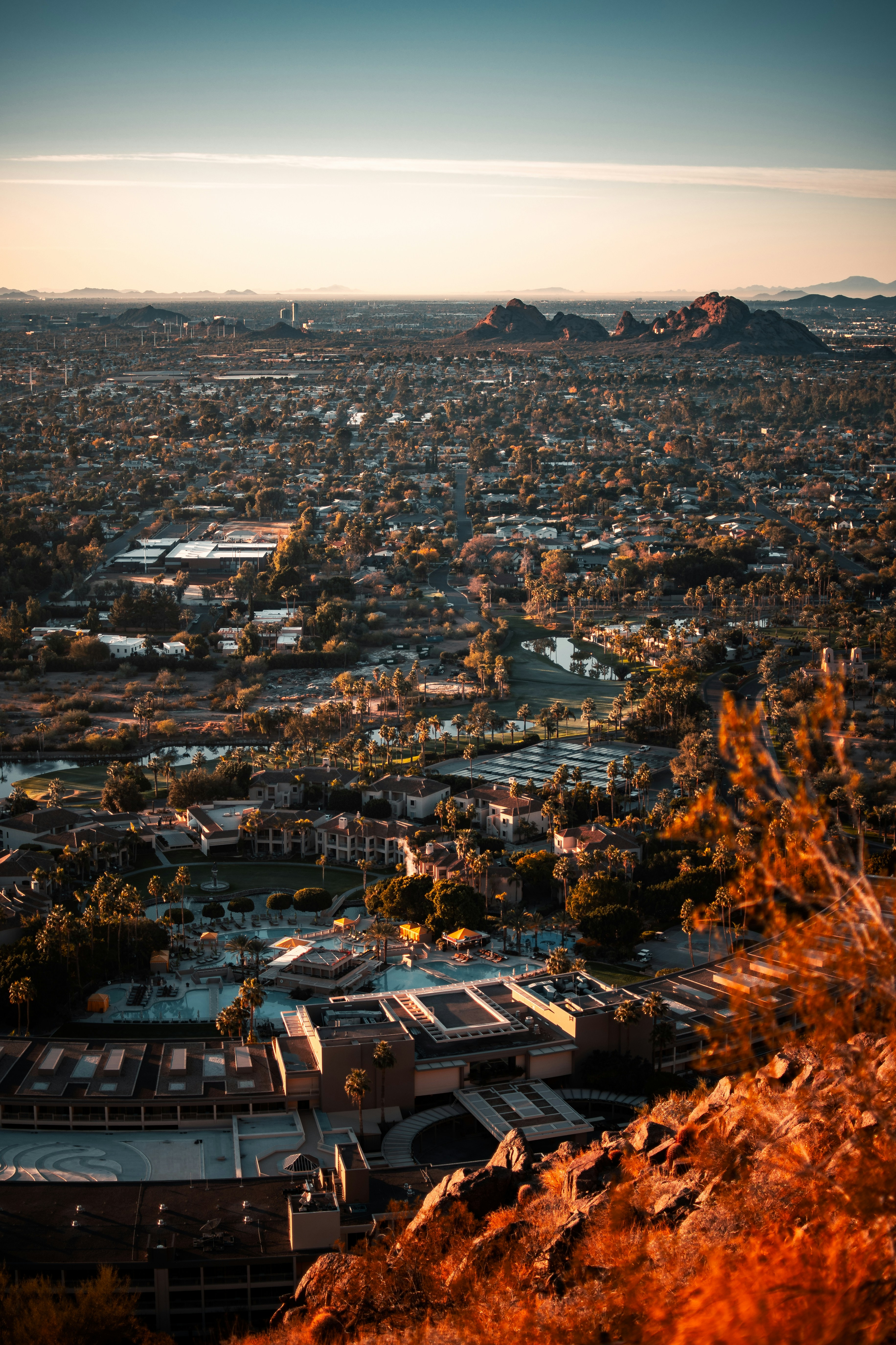 Aerial Phoenix skyline at sunset with mountains in background
